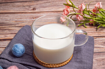 a cup of milk on wood background