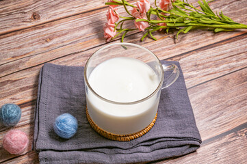a cup of milk on wood background