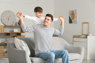 Happy father and his little son at home