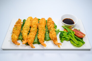 Fried shrimps and vegetables with white background