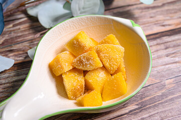 frozen mango with wood background