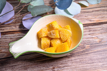 frozen mango with wood background