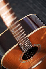 Fototapeta premium Abstract background of musical stringed instruments. Wood. Sound wave. Classical guitar close-up. Metal strings 
