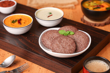 South Indian breakfast Ragi Idly, nachni idly, finger millet Idli, Sambar, coconut chutney healthy homemade dish Kerala, Karnataka, Tamil Nadu, India, Sri Lanka. steam cooked finger millet batter. 