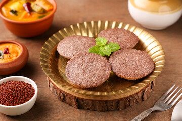 South Indian breakfast Ragi Idly, nachni idly, finger millet Idli in golden plate Sambar, coconut chutney healthy homemade dish Kerala, Karnataka, Tamil Nadu, India, Sri Lanka. steam cooked food. 