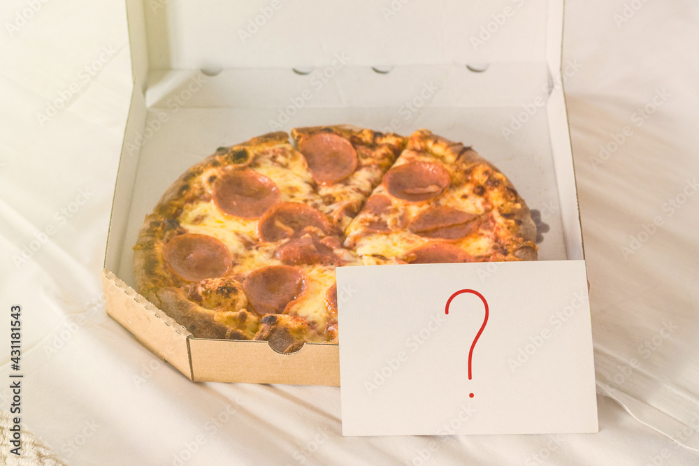Wall mural Open box of pizza on the big bed and card with question mark. Concept - Wall murals