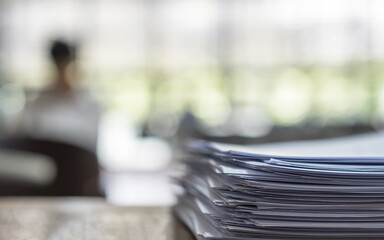 Exam answer sheet pile, blurry application document paperwork stack on office work table in...