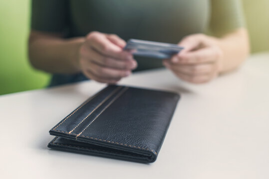 Cropped image of  woman hands with folder and bill on the table of cafe. visitor of restaurant ready to pay by credit card