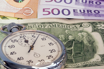 Money macro shot. The stopwatch lies in the center of the banknote layer. Clock. Time is money     ...