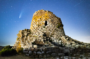 A blue sky with the Neowise comet and a Sardinian Nuraghe. High quality photo