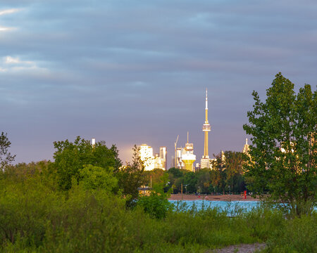 Looking west from the Kew Beach Dog park in Toronto's Beaches neighbourhood across Ashbridges Bay toward the downtown skyline and the CN Tower as the sun rises..
