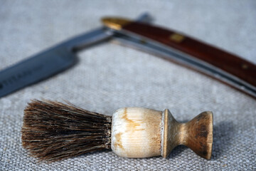 Barbershop. Shaving tools dangerous razor, blades, shaving brush thinning scissors, combs lie on a...