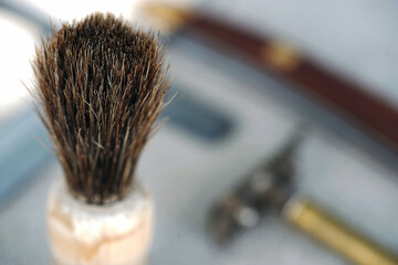 Barbershop. Shaving tools dangerous razor, blades, shaving brush thinning scissors, combs lie on a...