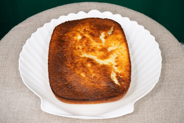 Rectangular pie on a glass plate. Homemade baking. Selective focus bread. Flour products. A pie with a delicious crust. Bakery. Cake                                 