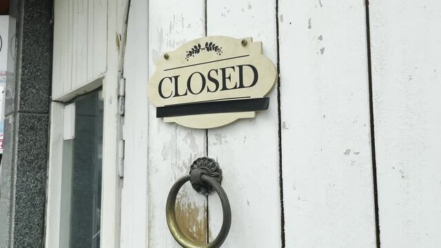 Closed sign hanging on door a small coffee store  it was closed.