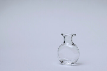 Transparent mini bottle on a white background