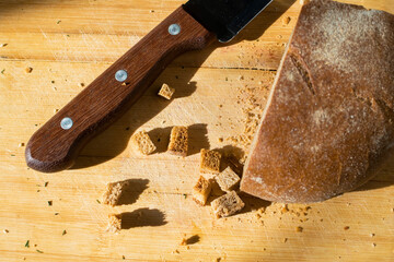 Wooden knife handle and sliced bread on the table