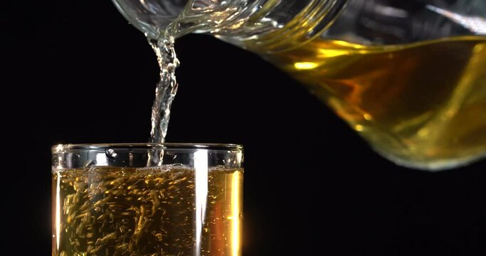 close-up. apple juice is poured into a glass