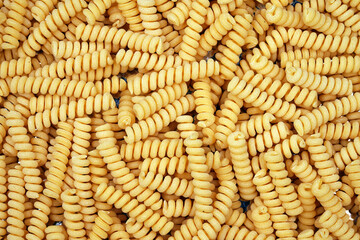 Spiral pasta background. Close-up of raw spaghetti, italian food. Garnish. Flour products. Paste.                           