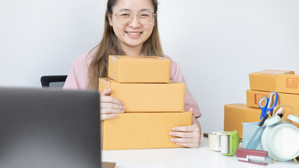 Young woman was happy after receiving an order from an internet customer, New business style for young people working at home and owning businesses, Sell online or Online sell concept.