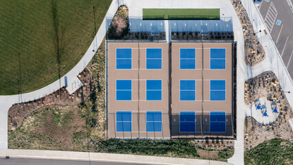 Overhead aerial of multiple pickle ball fields with some landscaping around them.
