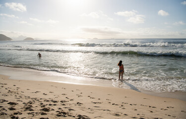  Citizens swim and sunbathe on the beach of Copacabana