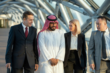 A group of intercultural people in formalwear standing in a building