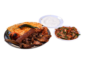 Traditional oriental mixed kebab and shashlik skewer with tomato and flatbread on white background. Turkish traditional kebabs. (karisik kebap)