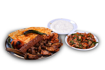 Traditional oriental mixed kebab and shashlik skewer with tomato and flatbread on white background. Turkish traditional kebabs. (karisik kebap)
