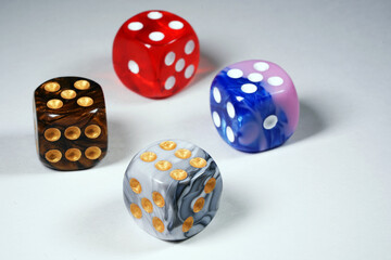 Multicolored dices isolated on white background.  Red, brown, blue and gray cubes. Playing cubes. Entertainment and hobbies. Gambling. Winnings                                                         