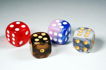 Multicolored dices isolated on white background.  Red, brown, blue and gray cubes. Playing cubes. Entertainment and hobbies. Gambling. Winnings                                                         