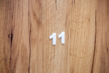 Wooden door of the room in the hotel with number 11