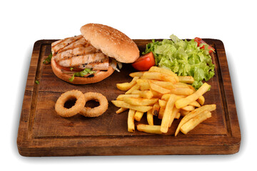 homemade hamburger, french fries and onion rings. Hamburger on wooden presentation plate top view. white background