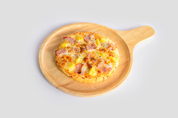 Handmade Hawaiian Pizza served on a wooden tray isolated with white background