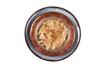 Turkish ravioli - manti (Kastamonu halucka) yoghurt, 
red pepper and mint. Turkish traditional food in white background top view. old turkish copper plate