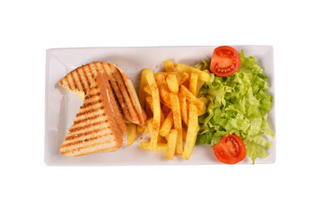 toast and french fries. greens and tomatoes. on a plate over a white background. turkish toast top view