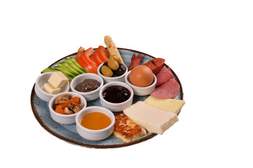 traditional turkish breakfast plate close up vegetables, cheese, olives and halal turkey salami. Turkish breakfast on white background