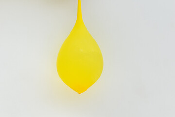 picture of yellow balloon filled with water and hanging