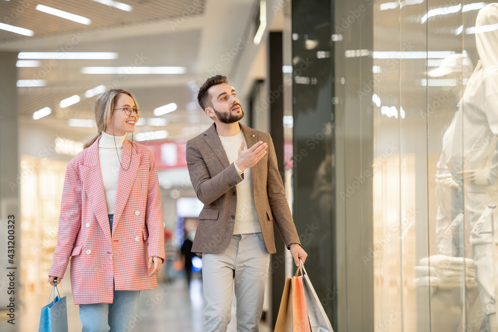 Wall mural a man and woman shopping in contemporary mall