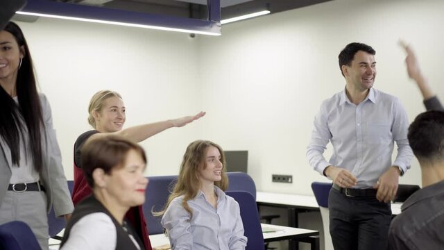 Group of colleagues handstack in office. Cheerful successful Caucasian men and women stacking hands rejoicing business startup success in workspace. Teamwork and happiness