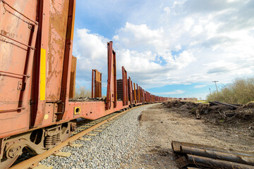 Long Line Of Open Side Logging Rail Cars