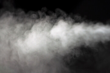 White fluffy clouds on a black background. Smoke. Clean fresh air. Steam.