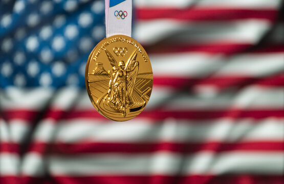 April 25, 2021 Tokyo, Japan. Gold Medal Of The XXXII Summer Olympic Games 2020 In Tokyo On The Background Of The US Flag.