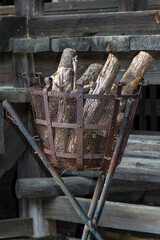 A iron basket in a stand with wood ready for ignition.
