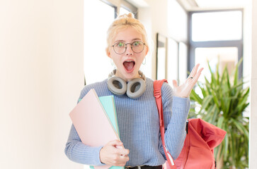 pretty student feeling happy, excited, surprised or shocked, smiling and astonished at something...