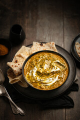 Bol de palak paneer tomate et épinard indien avec naans