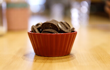chocolate biscuits in a porcelain pot on a light wooden table. selective focus. High quality photo
