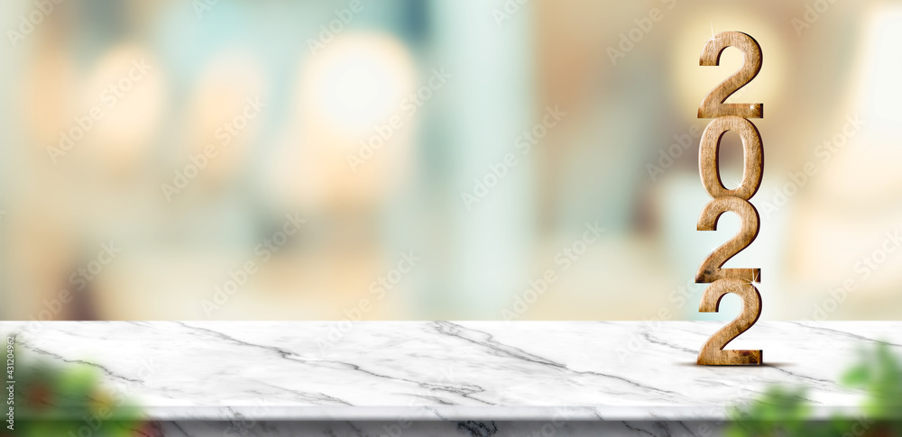 Poster new year 2022 (3d rendering) on white marble table at blur abstract bokeh light background with blur