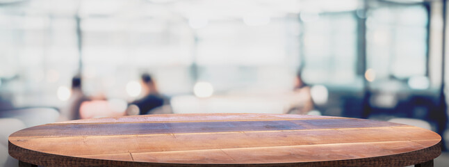 Empty round wood table with cafe restaurant blur background.copy space for display of product on...