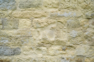 Stone wall bricked with strong structure, photographed in daylight